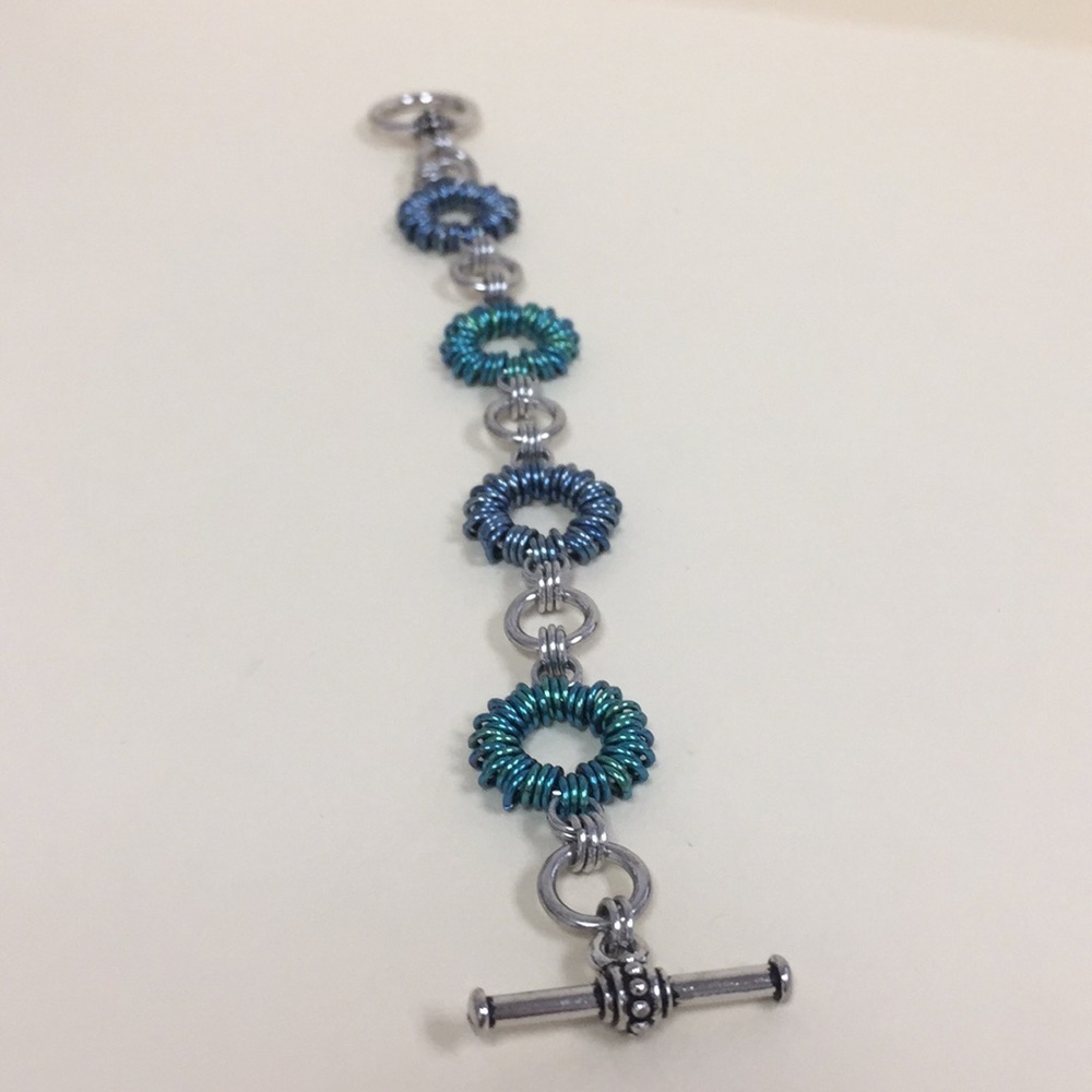 Hand woven blue and aqua ring bracelet.